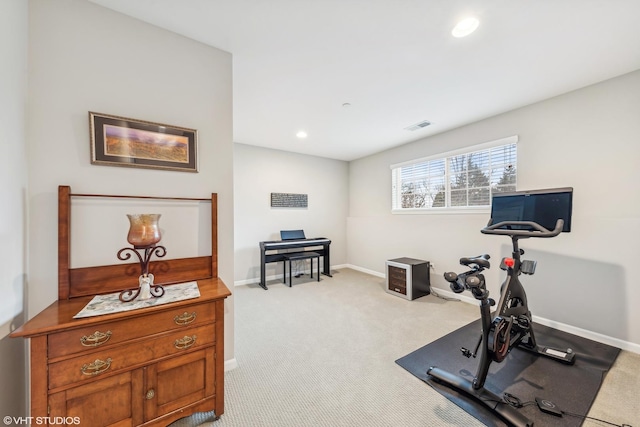 workout room featuring light colored carpet