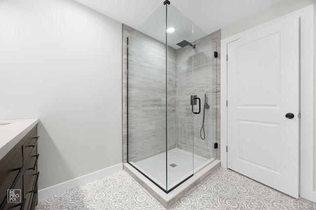 bathroom featuring tile patterned floors, vanity, and a shower with shower door