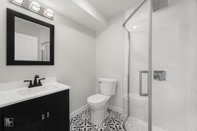 bathroom with vanity, a shower with shower door, and toilet