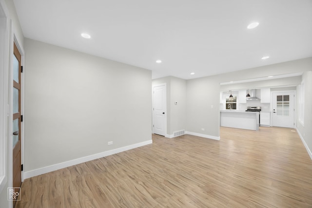 unfurnished living room featuring light wood-type flooring