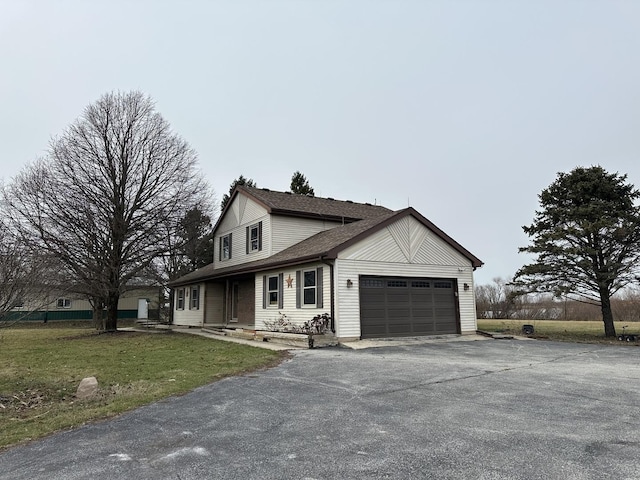 view of front of house with a garage and a front lawn