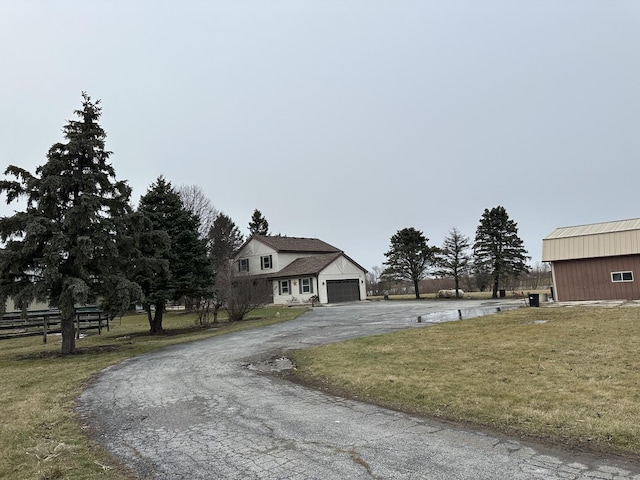 view of front of home with a front yard and a garage