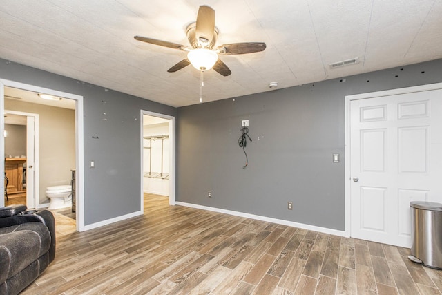 living room with wood-type flooring and ceiling fan