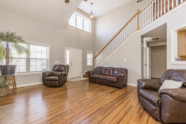 living room featuring hardwood / wood-style floors and a towering ceiling