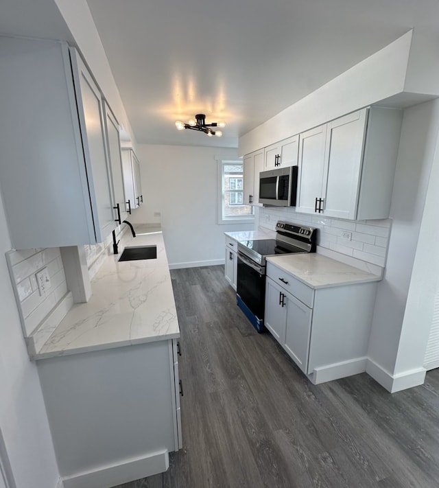 kitchen with light stone countertops, dark wood-type flooring, sink, electric range, and white cabinetry