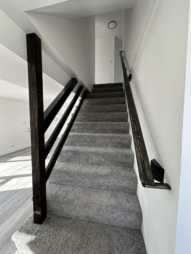 stairway featuring hardwood / wood-style flooring