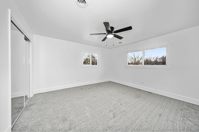 unfurnished bedroom featuring carpet, a closet, and ceiling fan