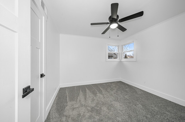 carpeted spare room featuring ceiling fan and crown molding