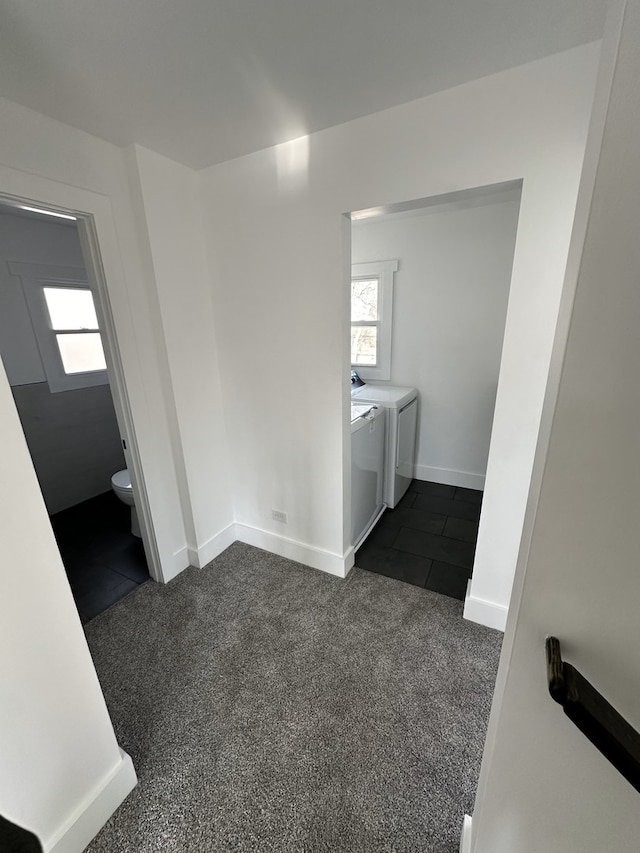 laundry area featuring dark colored carpet and washing machine and clothes dryer