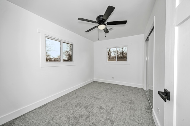 unfurnished bedroom featuring light colored carpet and ceiling fan