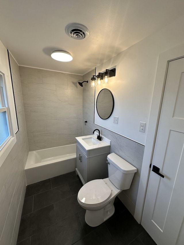 full bathroom featuring tile patterned flooring, vanity, toilet, and tile walls