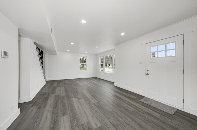 foyer featuring dark hardwood / wood-style flooring and crown molding