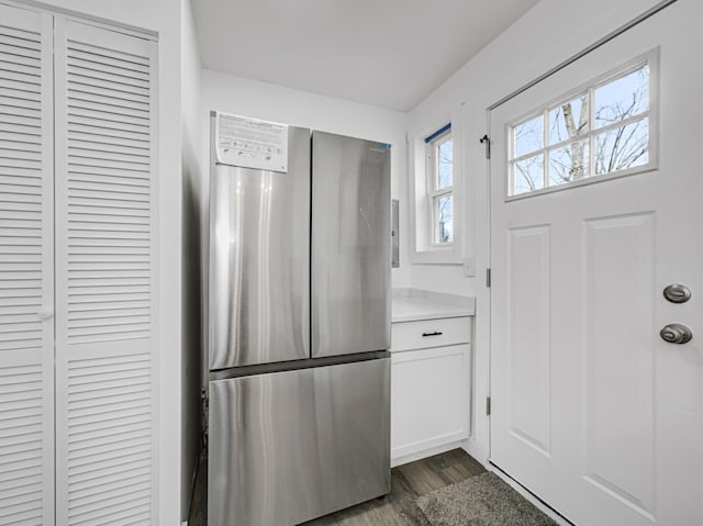 kitchen featuring white cabinets, dark hardwood / wood-style floors, and stainless steel fridge