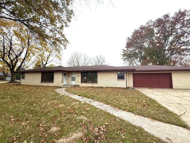 ranch-style house featuring a front yard and a garage