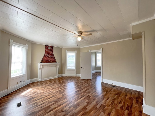 unfurnished living room with crown molding, ceiling fan, a fireplace, and dark wood-type flooring