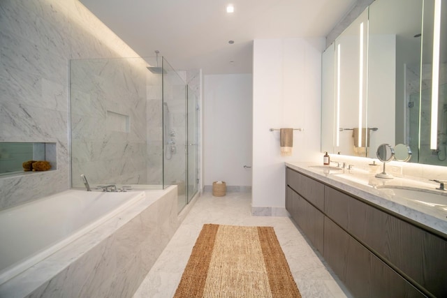 bathroom featuring plus walk in shower, vanity, and tile patterned flooring