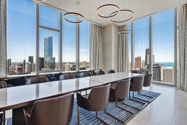 tiled dining area featuring a water view and expansive windows