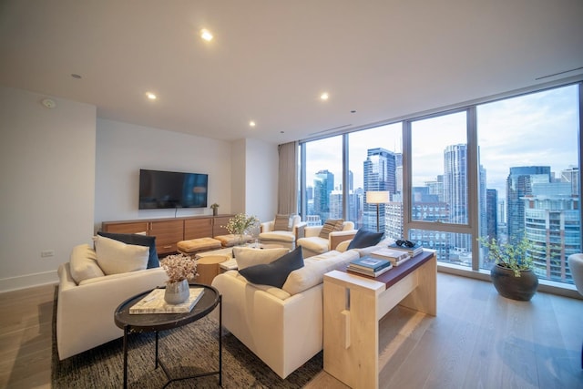 living room with hardwood / wood-style floors and floor to ceiling windows