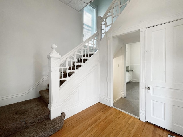 stairs featuring wood-type flooring