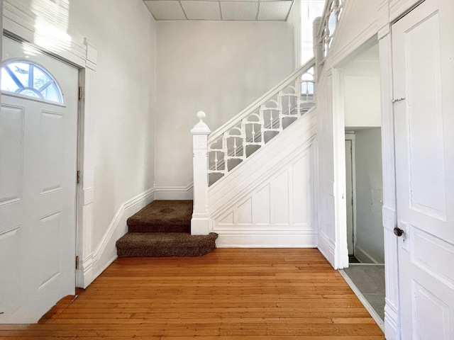 entrance foyer featuring hardwood / wood-style floors and a paneled ceiling