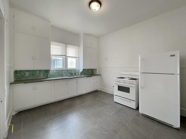 kitchen featuring decorative backsplash, white appliances, white cabinetry, and sink