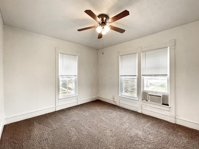 carpeted spare room featuring a textured ceiling, ceiling fan, and cooling unit