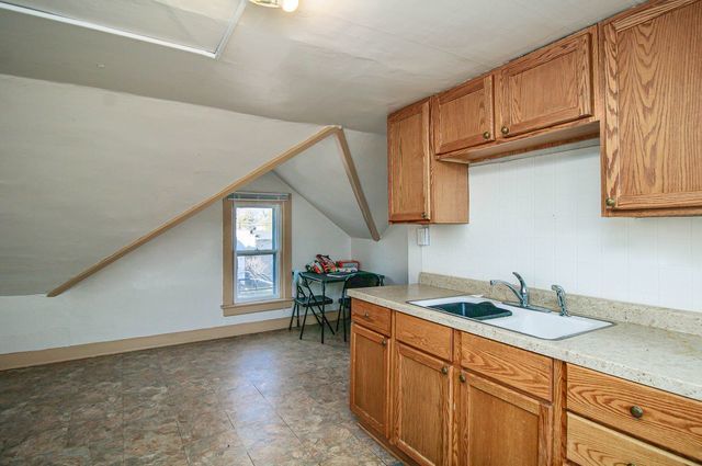 kitchen with lofted ceiling and sink