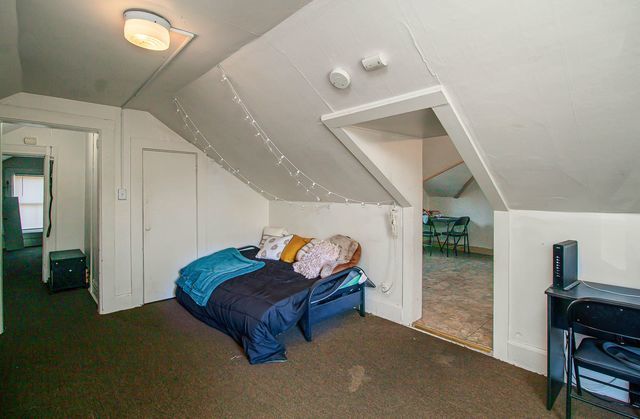 carpeted bedroom featuring lofted ceiling