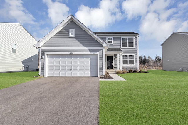 view of front of house featuring a front lawn and a garage