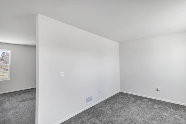 empty room with dark carpet