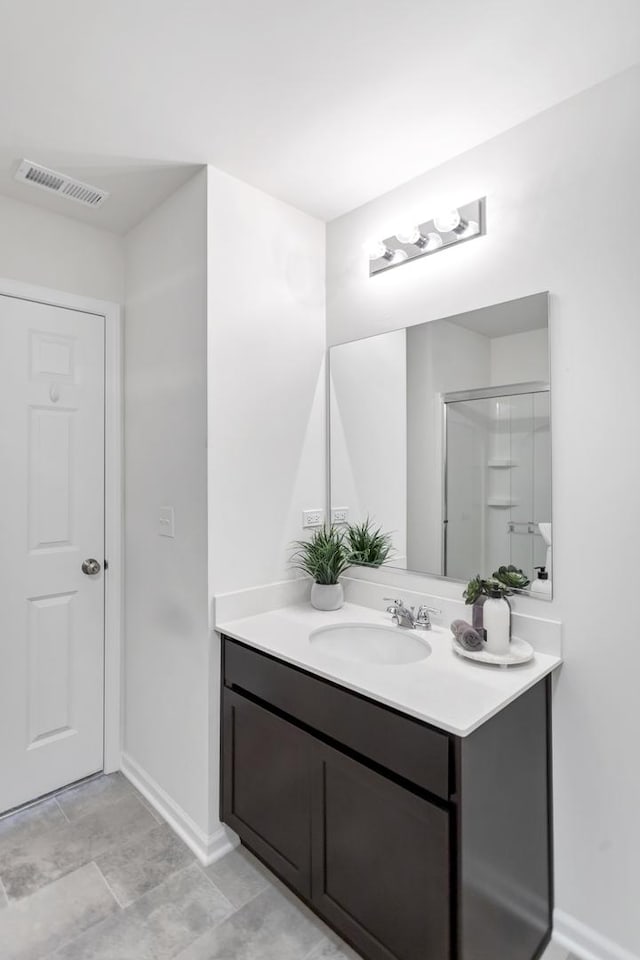 bathroom with walk in shower and vanity