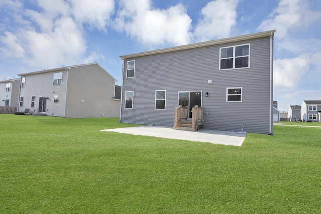 back of house featuring a patio and a yard