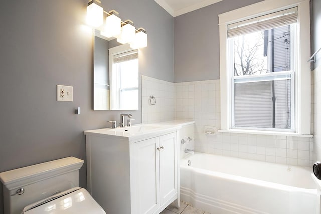 bathroom with tile patterned flooring, vanity, a tub to relax in, and a wealth of natural light