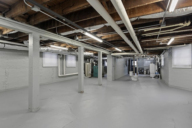 basement featuring heating unit and gas water heater