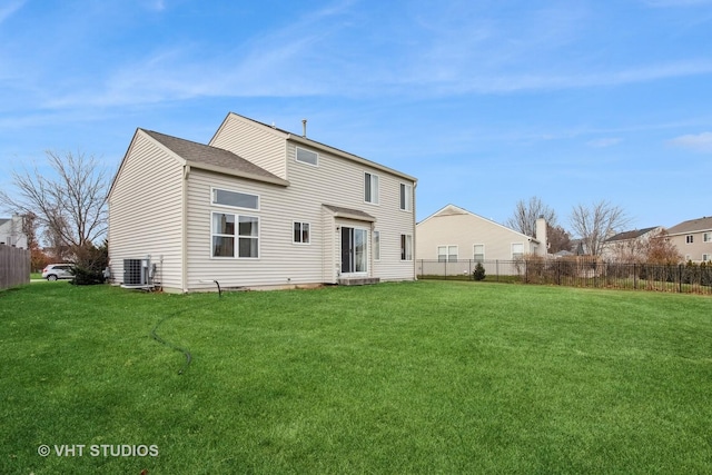 back of house with a lawn and central air condition unit