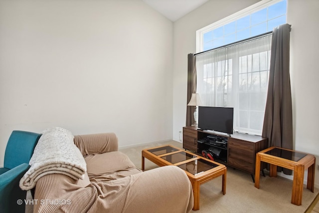 living room with light colored carpet and vaulted ceiling