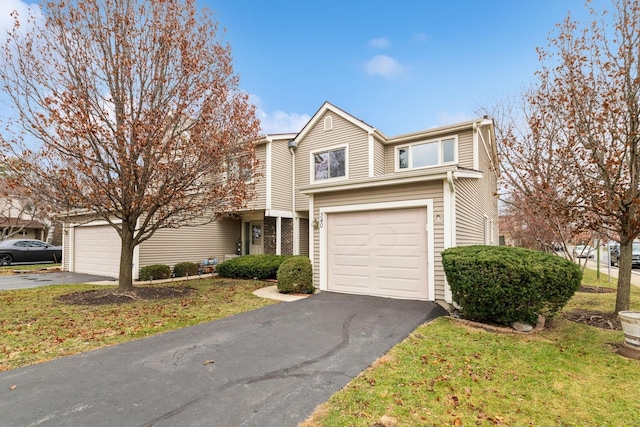 front facade with a garage and a front lawn