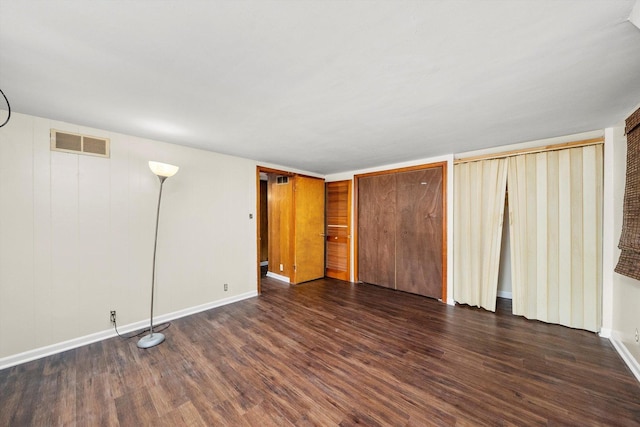 unfurnished bedroom featuring dark hardwood / wood-style floors