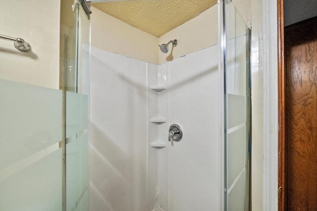 bathroom with a textured ceiling and walk in shower