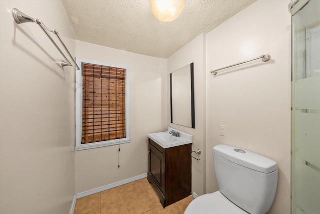 bathroom with vanity, tile patterned floors, a textured ceiling, and toilet