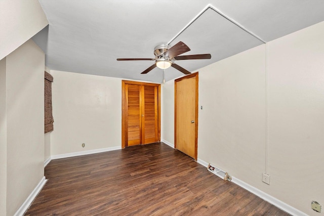 spare room featuring ceiling fan and dark wood-type flooring