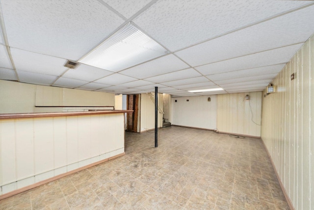 basement featuring a drop ceiling