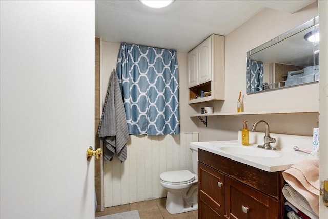 bathroom featuring tile patterned flooring, vanity, and toilet