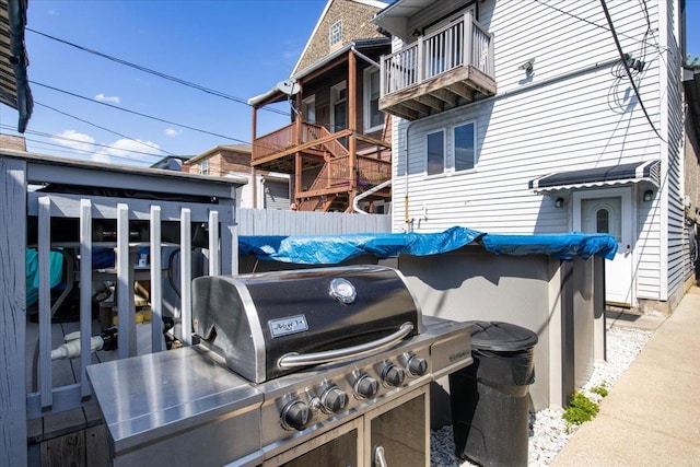 view of patio featuring a grill and a balcony