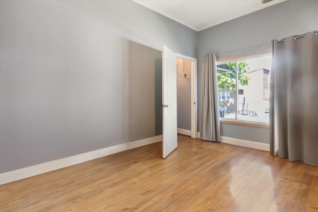 unfurnished bedroom featuring light hardwood / wood-style floors and crown molding