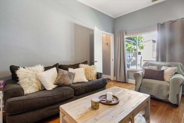 living room with hardwood / wood-style flooring and ornamental molding