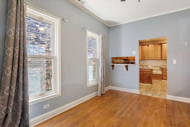 interior space with crown molding and light hardwood / wood-style floors