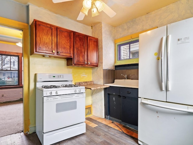 kitchen with ceiling fan, light wood-type flooring, white appliances, and a wealth of natural light