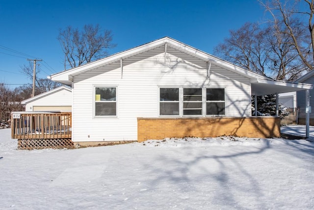 snow covered property with a wooden deck