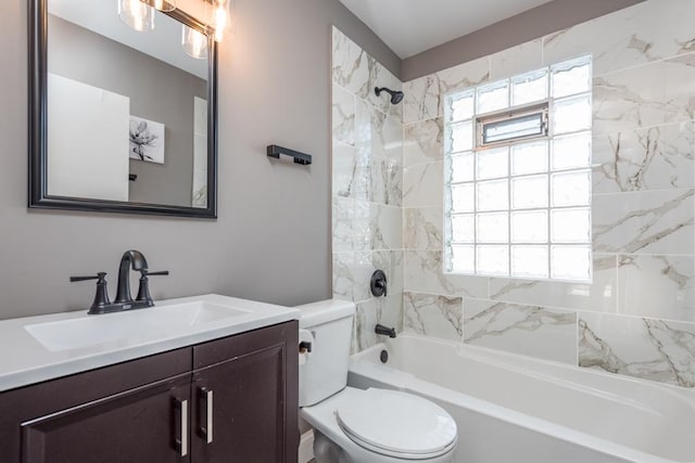 full bathroom featuring tiled shower / bath combo, vanity, plenty of natural light, and toilet